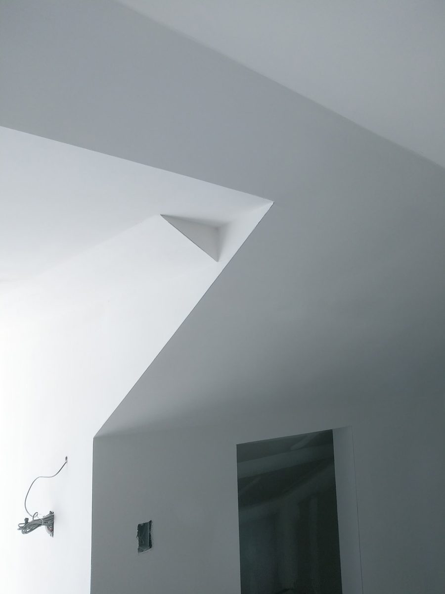 Smooth finished drywall walls and angled ceiling